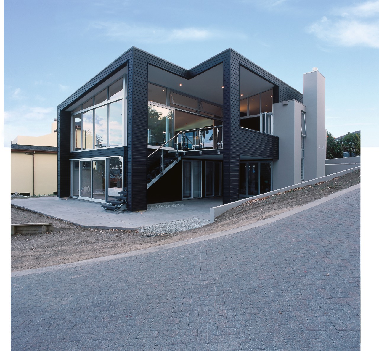 Exterior of home with dark stained weatherboard cladding. architecture, building, commercial building, elevation, facade, home, house, property, real estate, gray