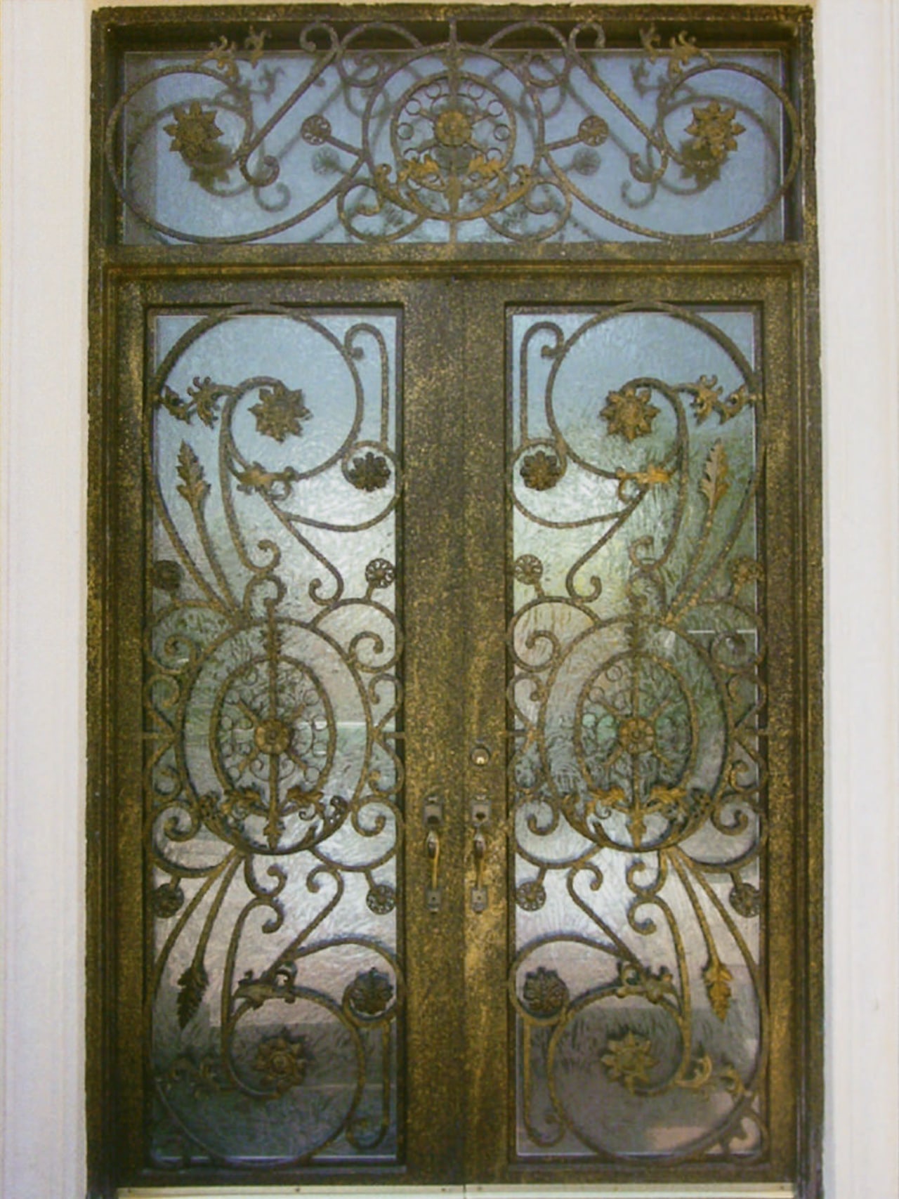 Close up view of a wooden door with door, glass, iron, metal, brown, gray