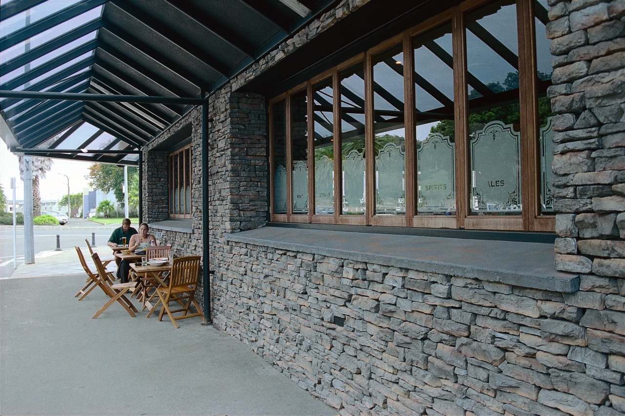 Exterior view of building with stone cladding, timber house, outdoor structure, porch, real estate, window, gray, black