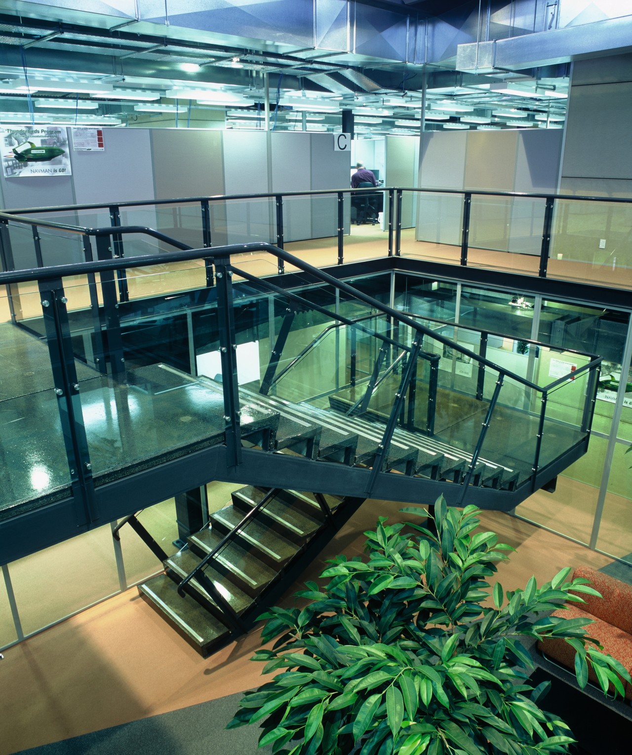 A view of a large metal and galss glass, leisure centre, teal