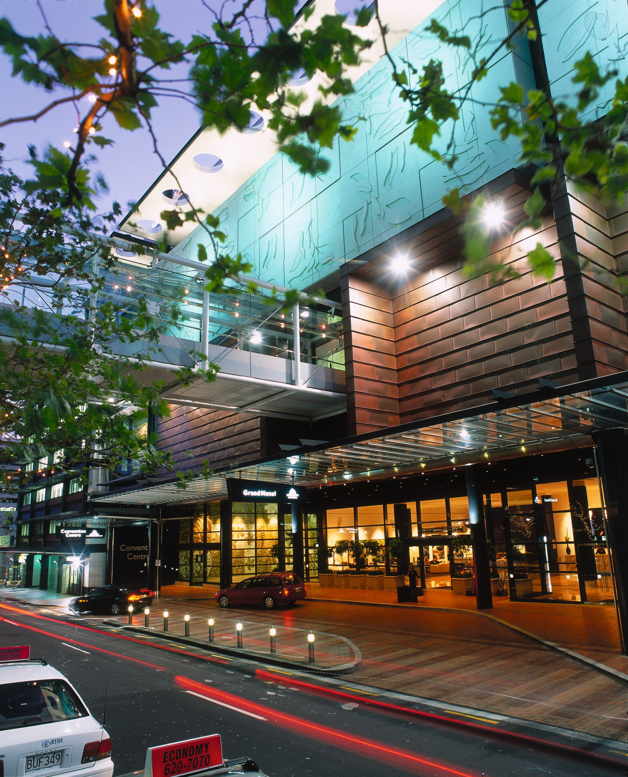 Exterior view of SkyCity Grand Hotel with glass architecture, building, city, downtown, facade, metropolis, metropolitan area, mixed use, neighbourhood, real estate, tree, black