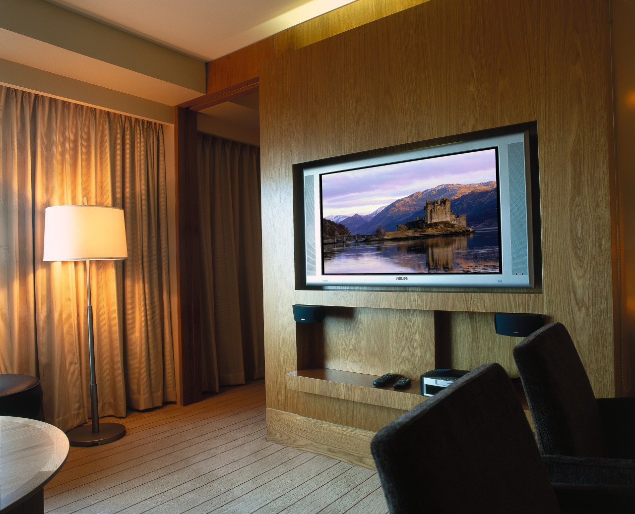 Hotel room with wall mounted plasma tv. ceiling, display device, entertainment, interior design, living room, real estate, room, suite, wall, brown
