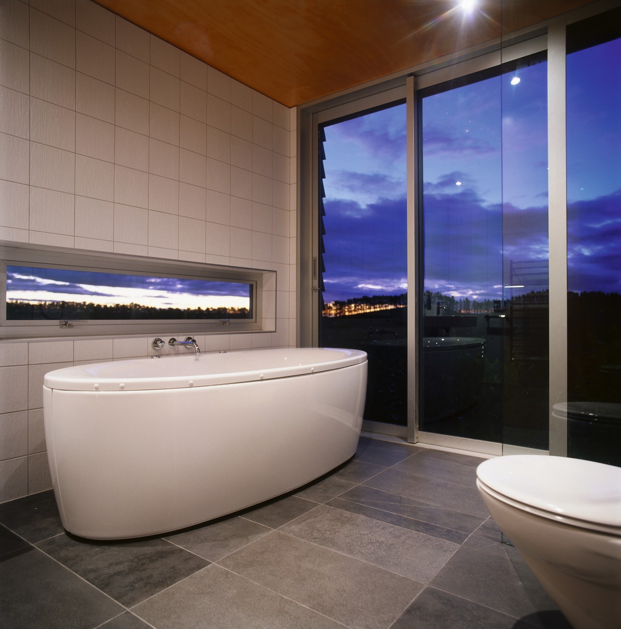 Bathroom with standalone white bath, tiled floor and architecture, bathroom, bathtub, floor, flooring, interior design, property, real estate, gray