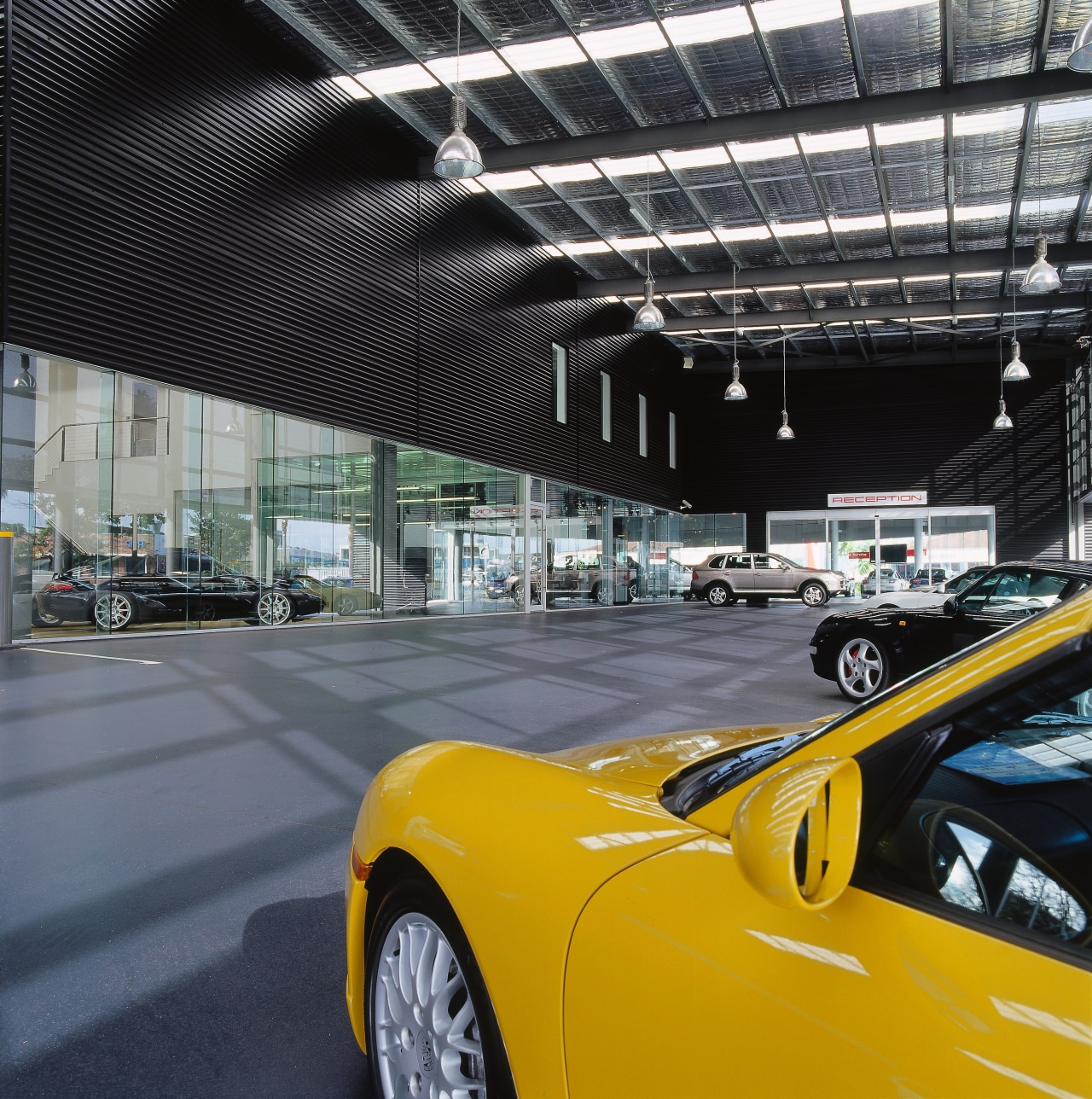view of the canopy looking into the showroom, auto show, automotive design, automotive exterior, car, land vehicle, luxury vehicle, motor vehicle, performance car, sports car, supercar, vehicle, yellow, black, gray