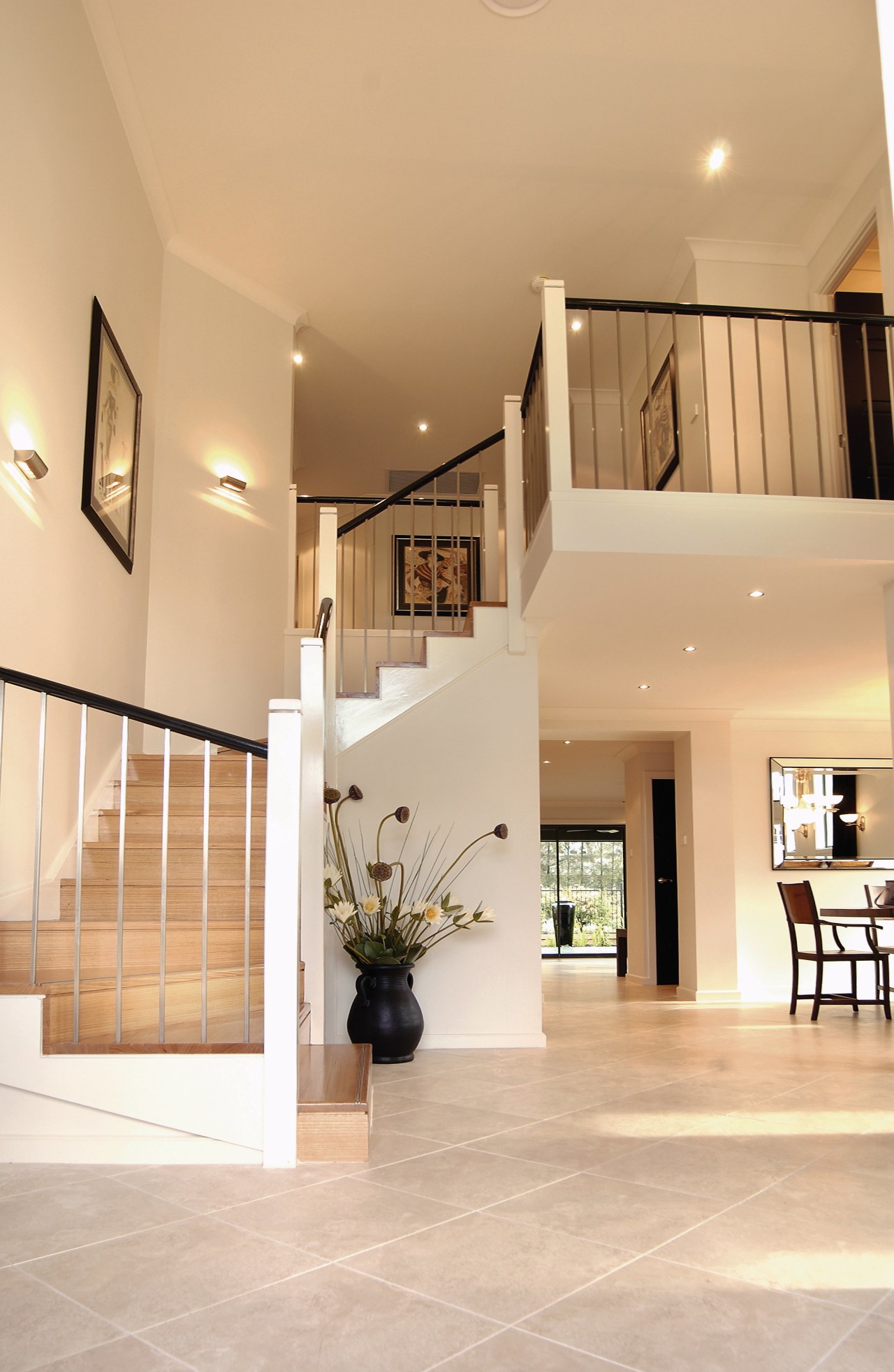 A view of a staircase, cream tiled floor, architecture, ceiling, daylighting, estate, floor, flooring, handrail, hardwood, home, house, interior design, living room, lobby, property, real estate, stairs, wood flooring, orange