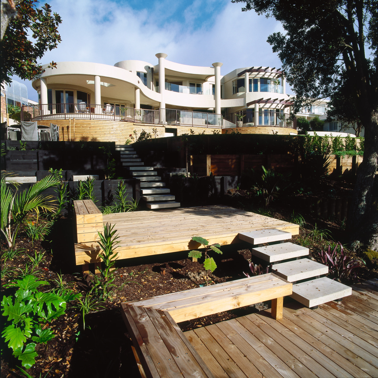 A view of the entire house from the architecture, cottage, deck, estate, home, house, outdoor structure, property, real estate, resort, black