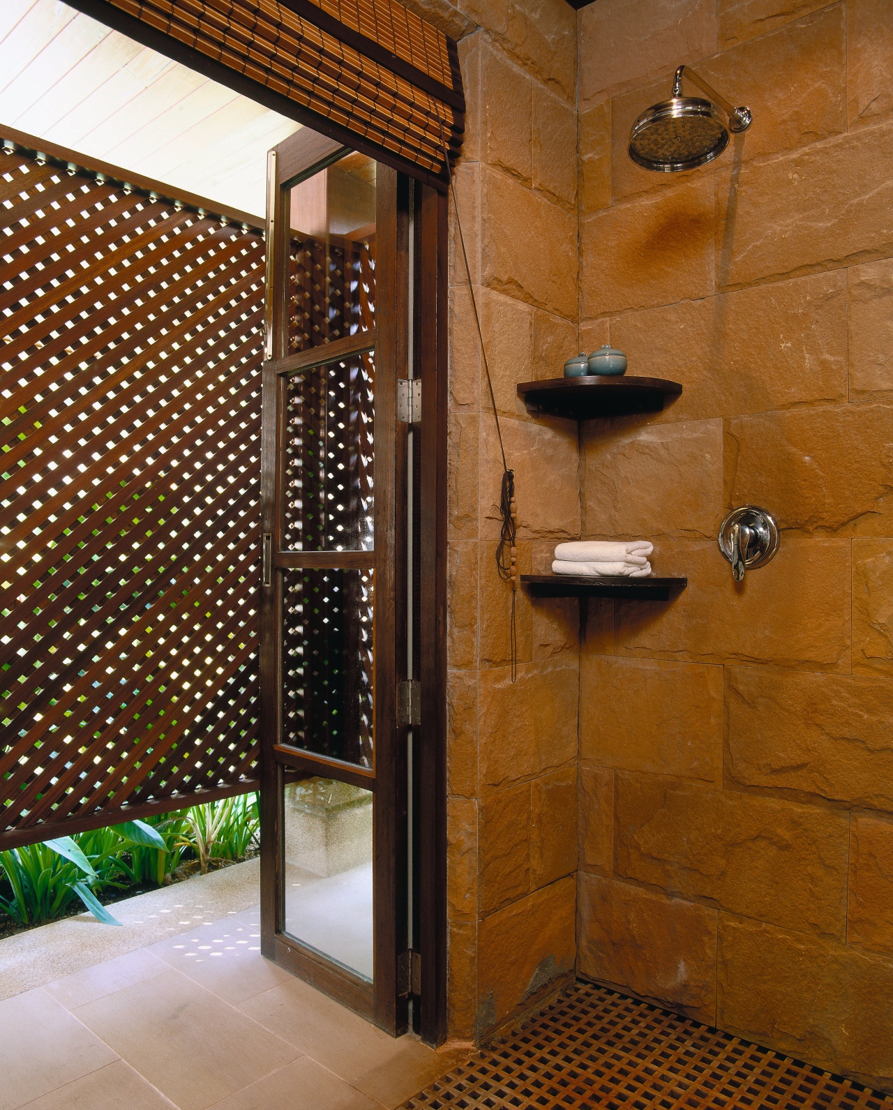 view of the bathroom featuring sandstone walls, glazed bathroom, interior design, room, tile, wall, brown