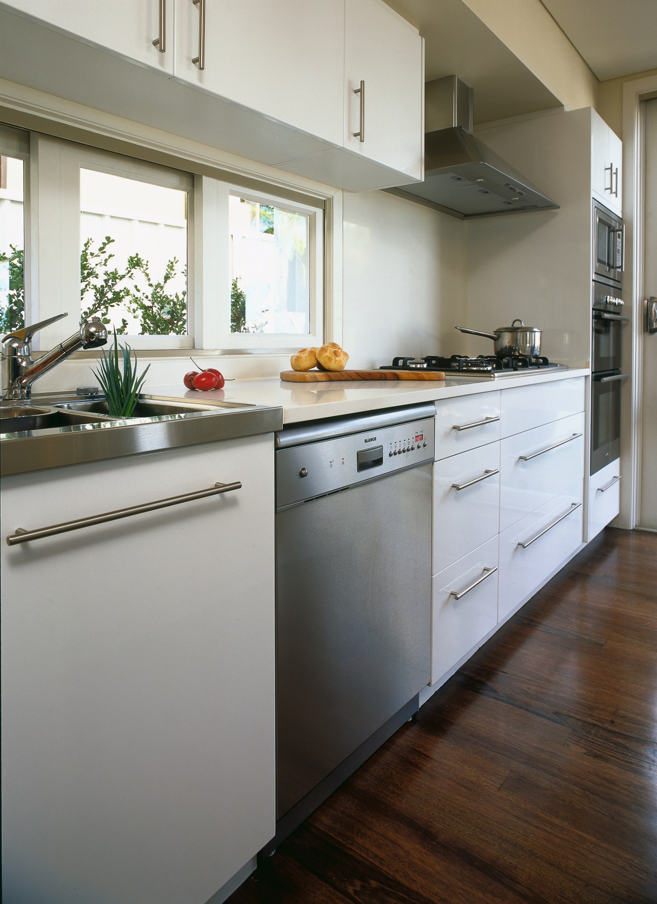 A vie wof a kitchen area, wooden flooring, cabinetry, countertop, cuisine classique, floor, flooring, hardwood, home appliance, interior design, kitchen, real estate, room, gray
