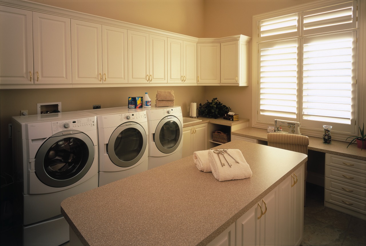 A view of the laundry ara, many white cabinetry, clothes dryer, countertop, home, home appliance, kitchen, laundry, laundry room, major appliance, room, washing machine, brown, orange