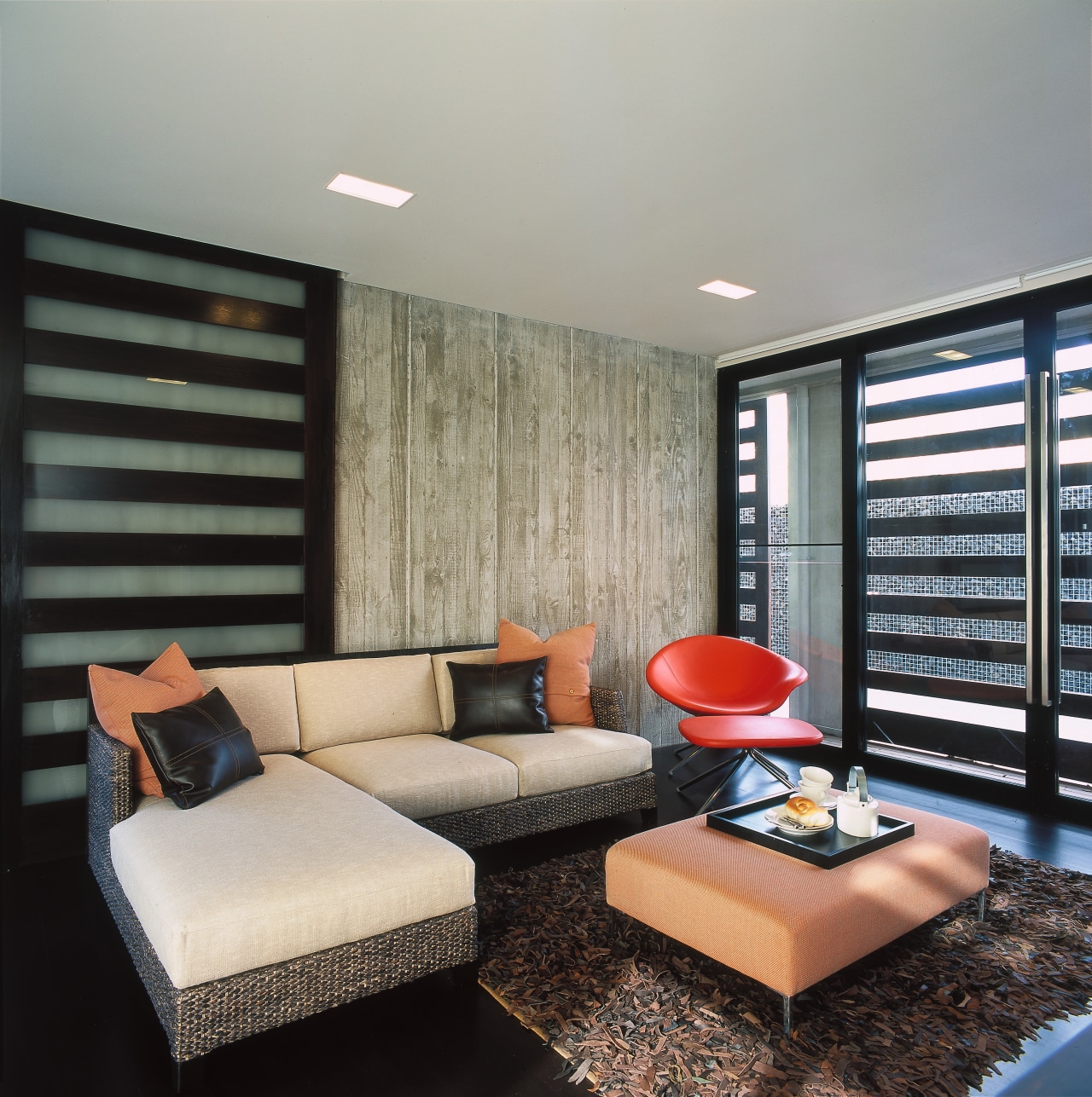 view of the entertainment lounge featuring sliding shutters ceiling, interior design, living room, real estate, room, window, window covering, gray, black