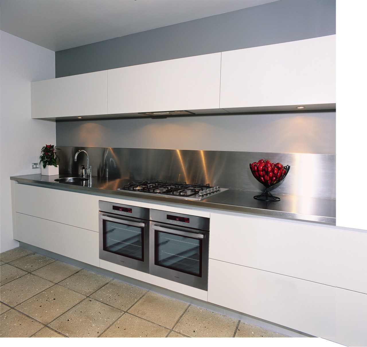 A view of a kitchen area, grey concrete countertop, gas stove, home appliance, kitchen, kitchen appliance, kitchen stove, white, gray