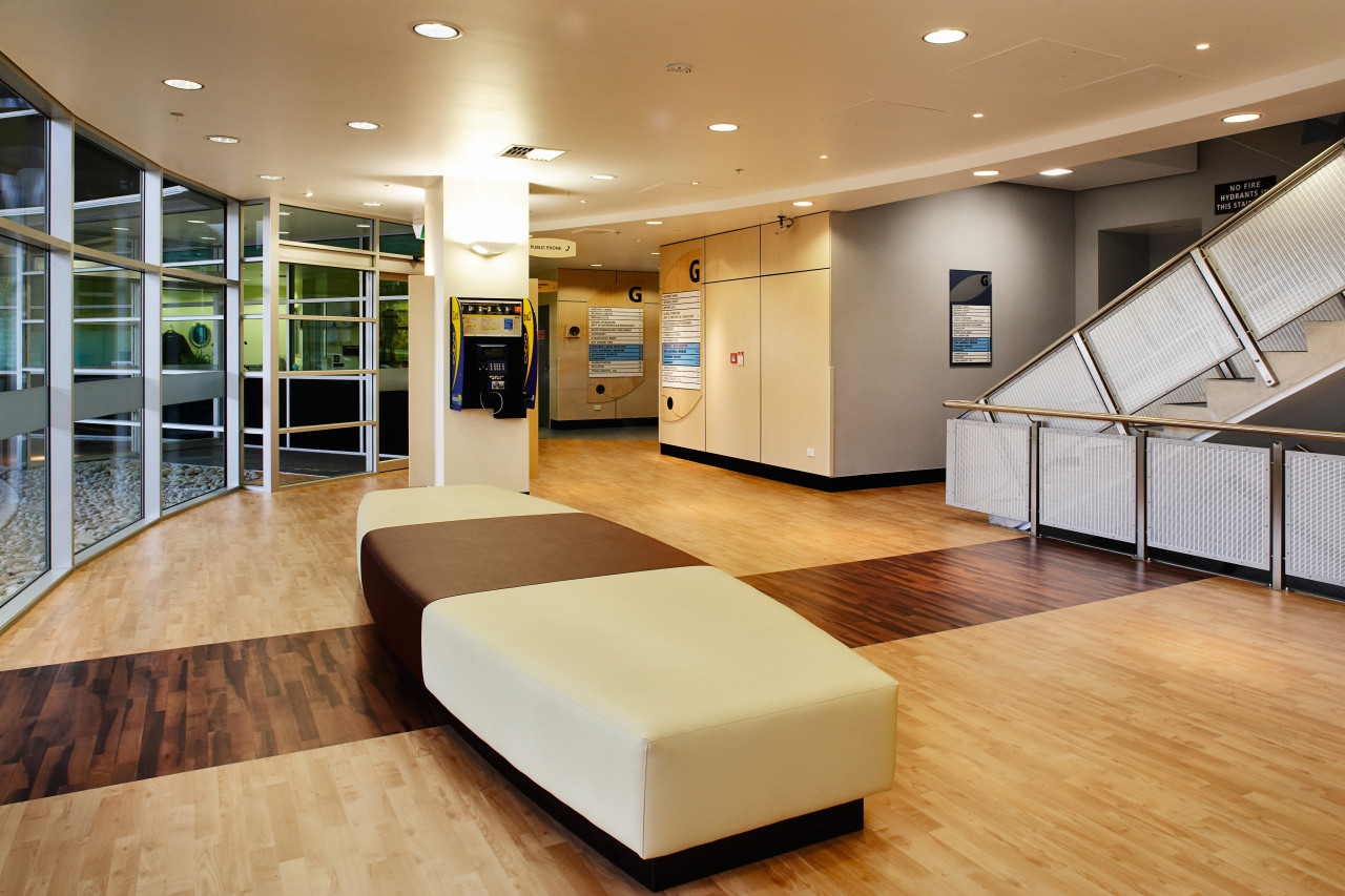 Lobby area of hospital with two toned flooring ceiling, floor, flooring, interior design, lobby, orange