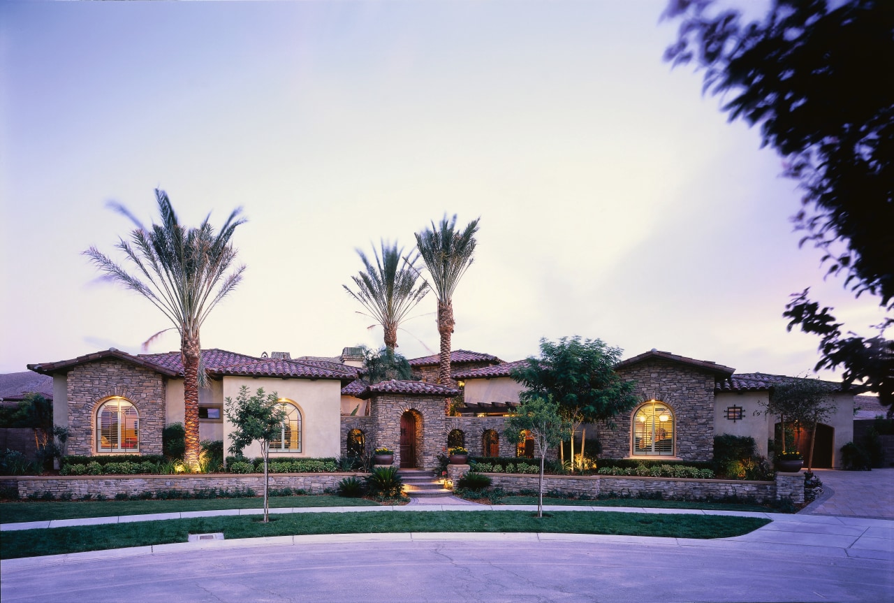 view of the mediteranean house  showing stone arecales, estate, hacienda, home, house, mansion, palm tree, property, real estate, residential area, resort, sky, tree, villa, white