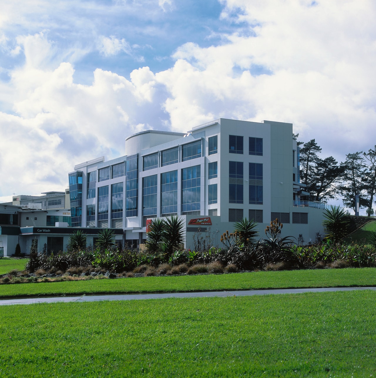 Exterior view of office building with aluminium cladding apartment, architecture, building, campus, commercial building, condominium, corporate headquarters, daytime, estate, facade, grass, headquarters, home, house, mixed use, property, real estate, residential area, sky, tree, white, green