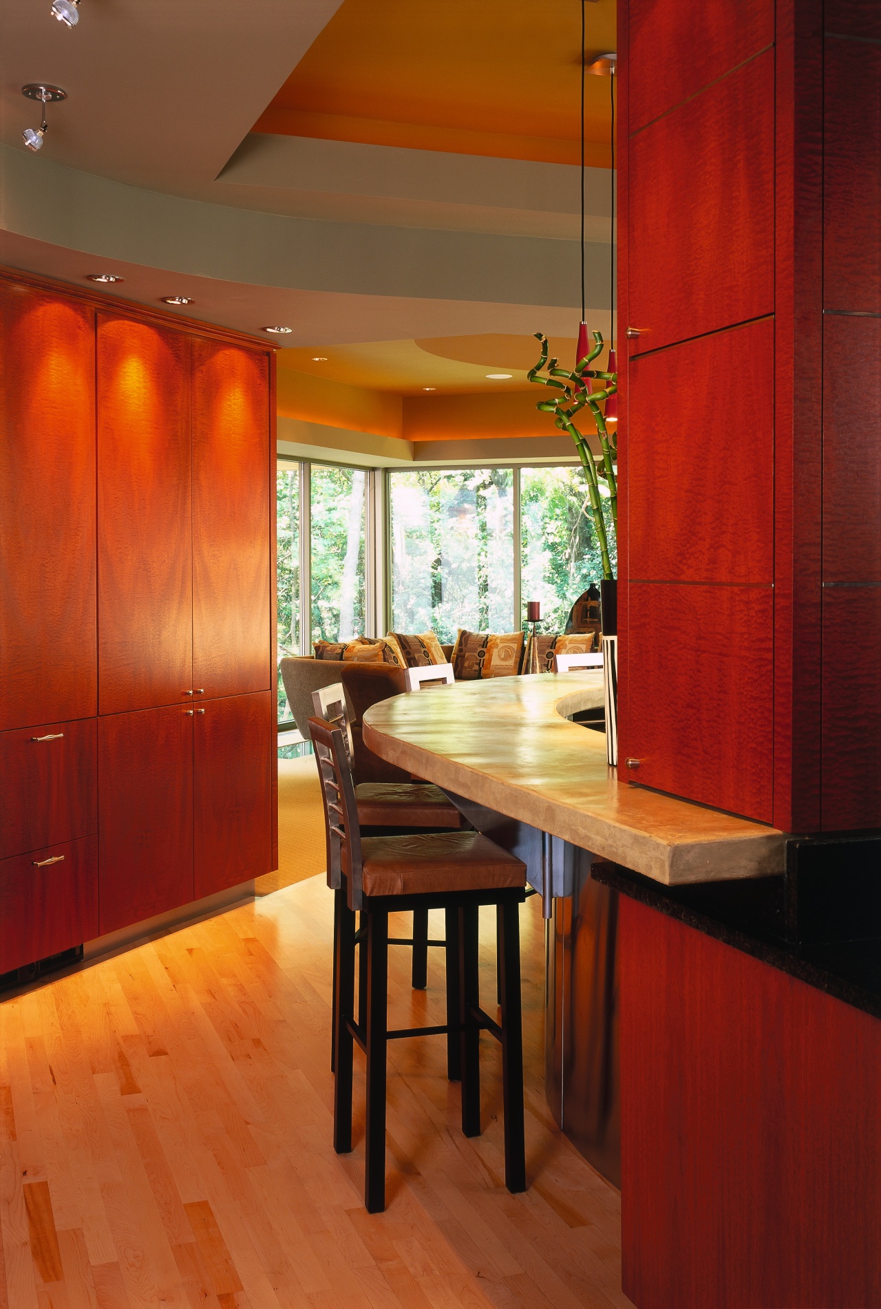 A view of the kitchen area, wooden cabinetry, architecture, ceiling, dining room, floor, flooring, furniture, hardwood, interior design, room, table, wall, window, wood, red, brown