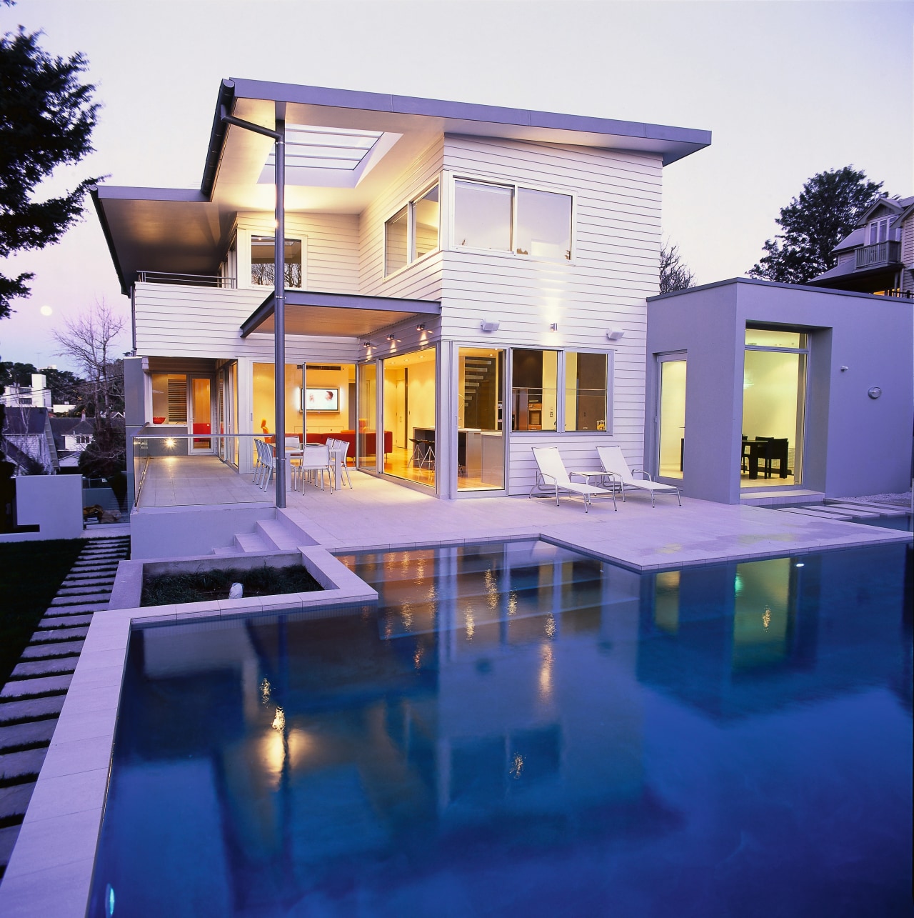 Exterior view of white two-storey weatherboard house with apartment, architecture, building, elevation, estate, facade, home, house, interior design, lighting, property, real estate, reflection, residential area, swimming pool, villa, window, blue, white