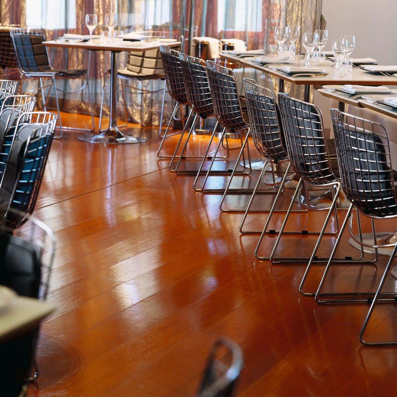 Restaurant dining area with timber flooring, chrome frame chair, floor, flooring, furniture, hardwood, interior design, laminate flooring, table, wood, wood flooring, brown