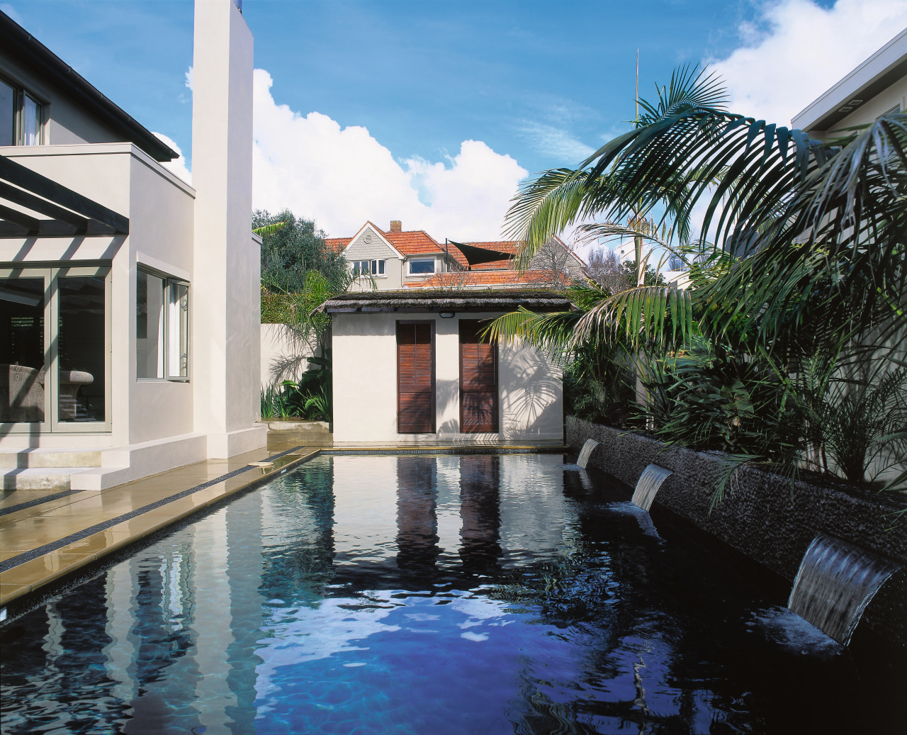 Long swimming pool with dark finish, water features, arecales, estate, hacienda, house, leisure, palm tree, property, real estate, reflecting pool, resort, swimming pool, villa, water, black