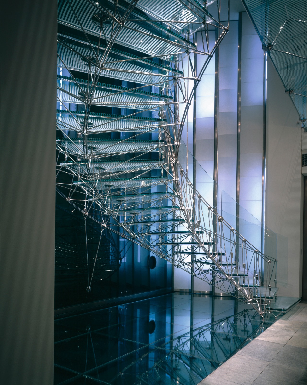 A view of the glass and metal stairway. architecture, building, daylighting, facade, glass, headquarters, line, metropolis, reflection, structure, teal, black