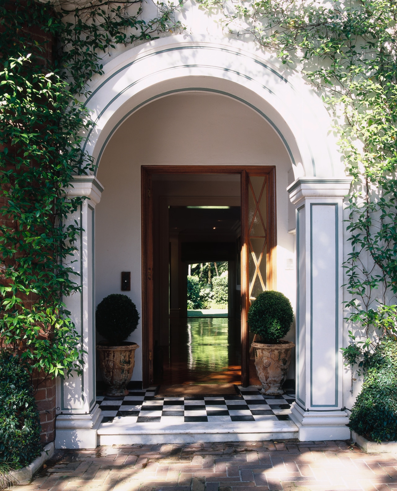 view of the formal entrance arch is indicative arch, architecture, brick, courtyard, door, estate, facade, home, house, outdoor structure, porch, real estate, structure, window, gray, black