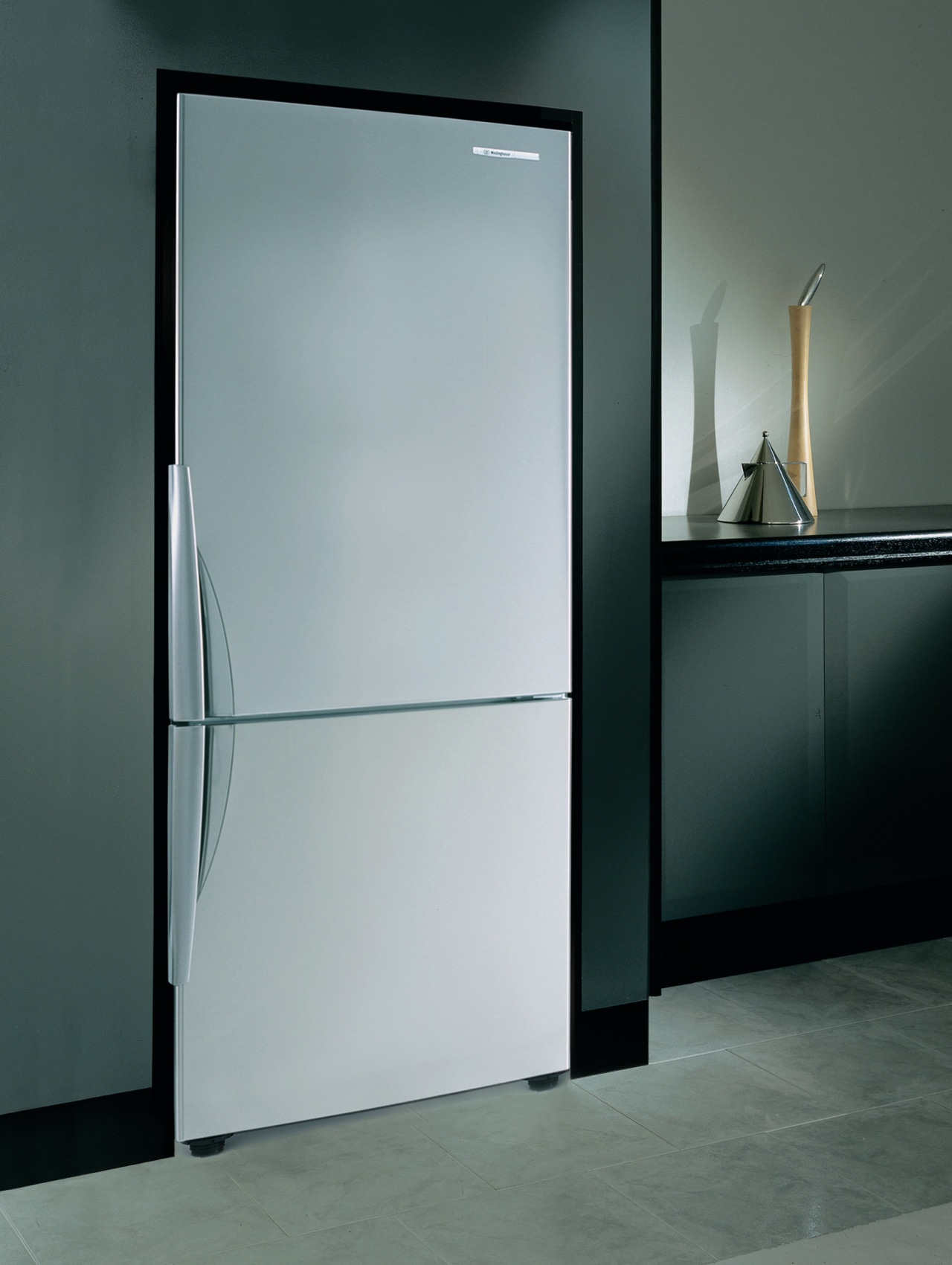 Refrigerator set into kitchen cabinetry. door, glass, product design, gray
