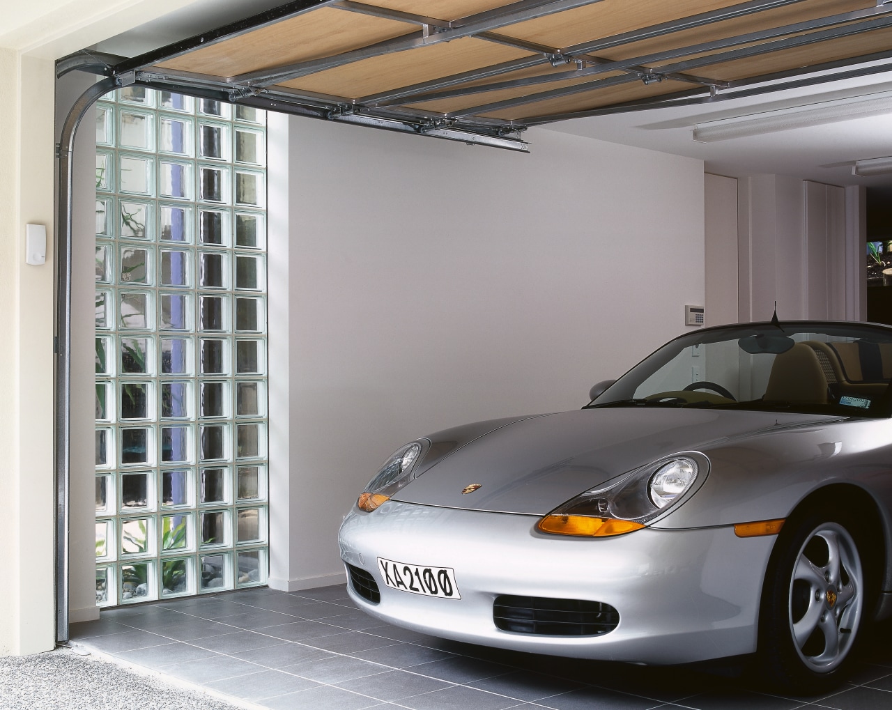 view of this garage featuring a garage window automotive design, automotive exterior, car, garage, material, motor vehicle, porsche, sports car, technology, vehicle, vehicle door, window, gray