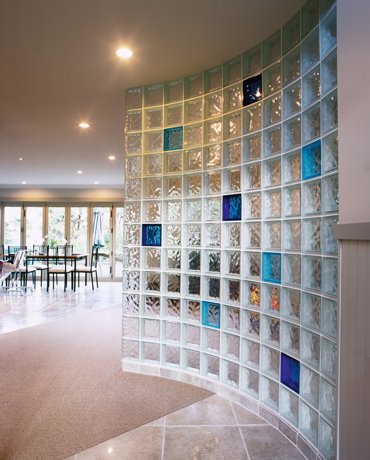 view of this glass block wall featuring solaris architecture, ceiling, daylighting, floor, flooring, glass, interior design, lobby, tile, wall, gray