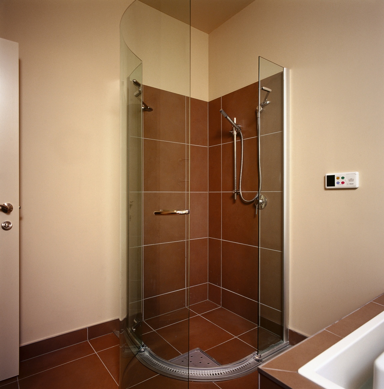 Frameless shower unit with brown wall and floor bathroom, door, floor, glass, plumbing fixture, room, shower, brown, orange