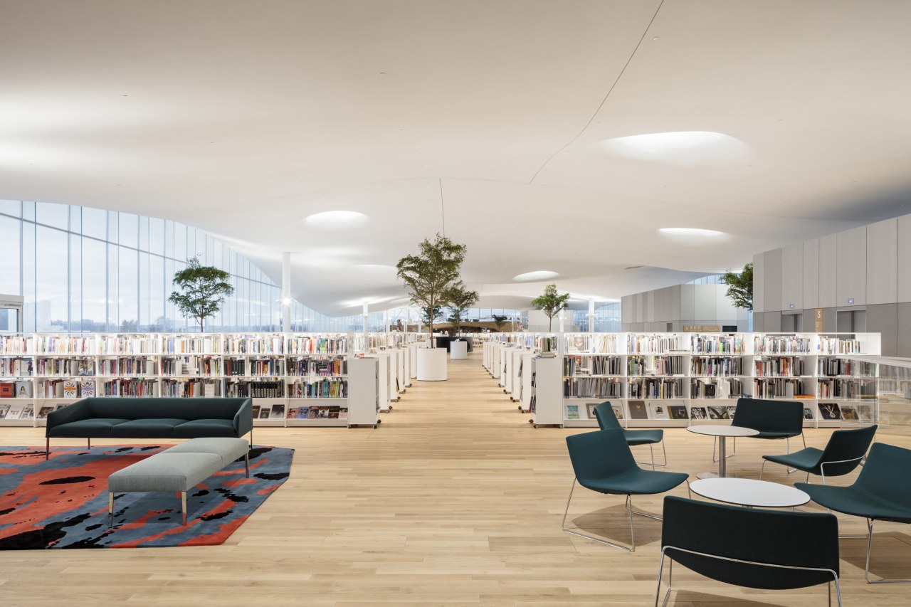 The innovative Helsinki library's structural design enables the architecture, building, ceiling, chair, design, floor, flooring, furniture, house, interior design, lobby, office, real estate, room, table, gray