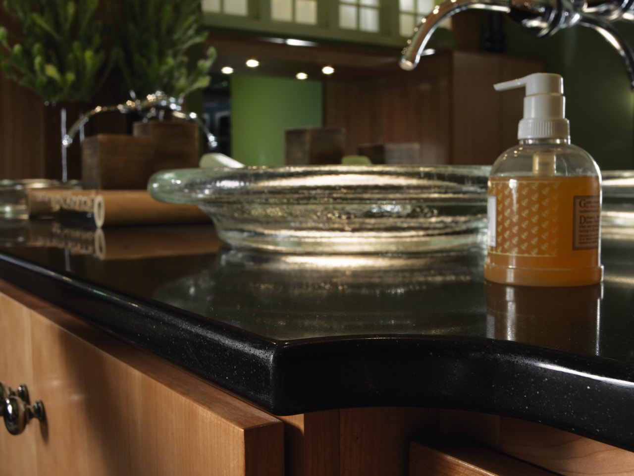 A view of a bathroom, wooden cabinetry, marble countertop, furniture, glass, kitchen, table, brown, black