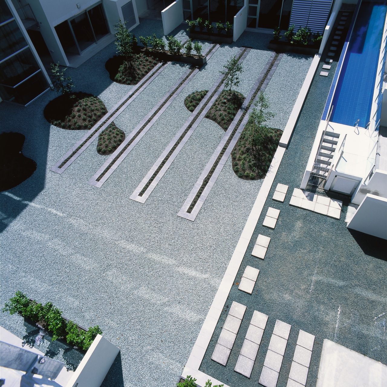 An exterior view of the central courtyard. architecture, condominium, courtyard, daylighting, floor, house, line, property, residential area, road surface, roof, urban design, walkway, black, white