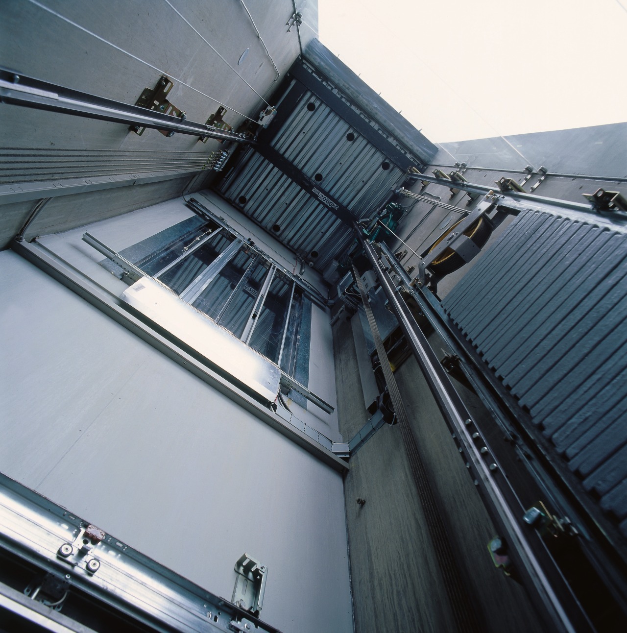 A view of the elevators within the complex. architecture, automotive exterior, building, daylighting, glass, line, roof, steel, gray, black