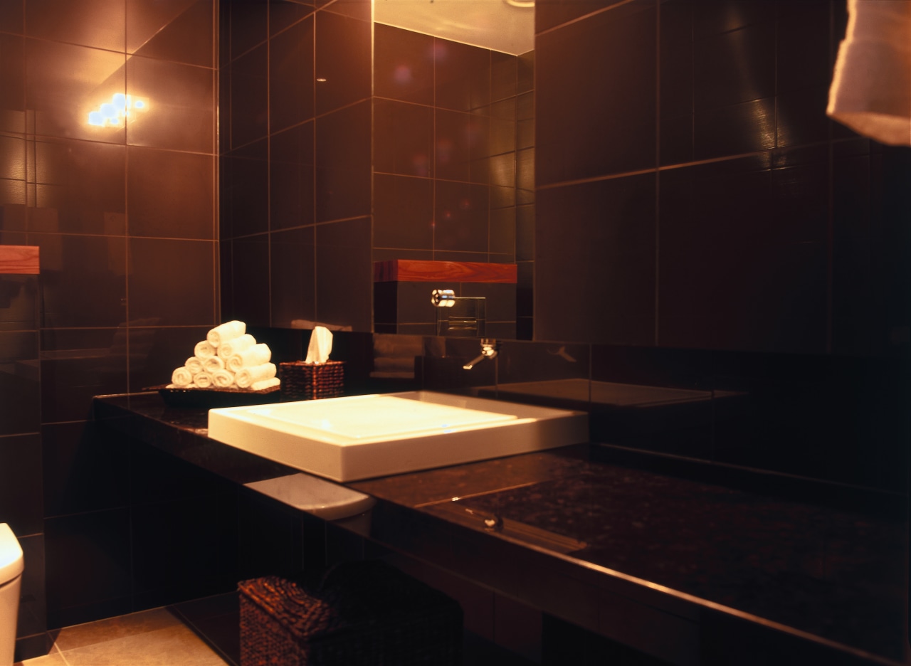 A view of the Kohler products used in bathroom, flooring, interior design, light, lighting, room, table, black