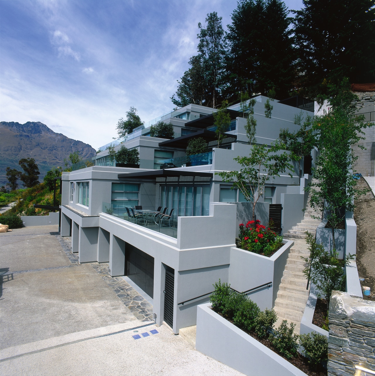 An exterior view of the entire apartment complex. architecture, condominium, facade, house, property, real estate, residential area, villa, gray