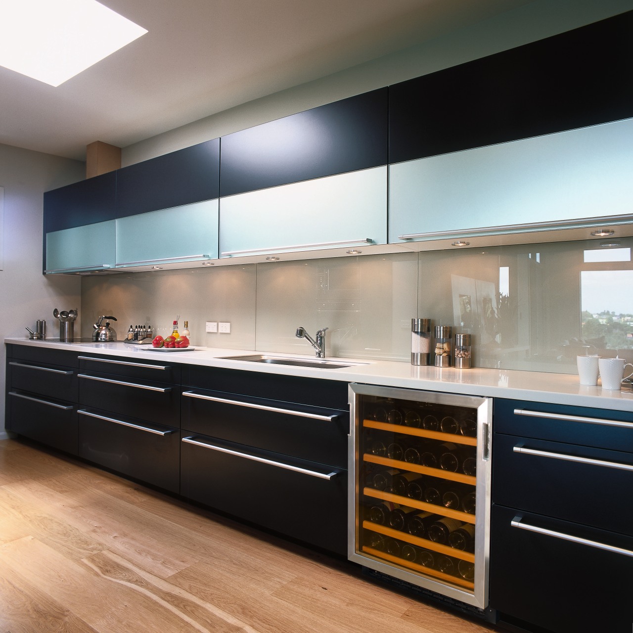 Kitchen with dark cabinetry, long chrome handles, and cabinetry, countertop, interior design, kitchen, black, gray