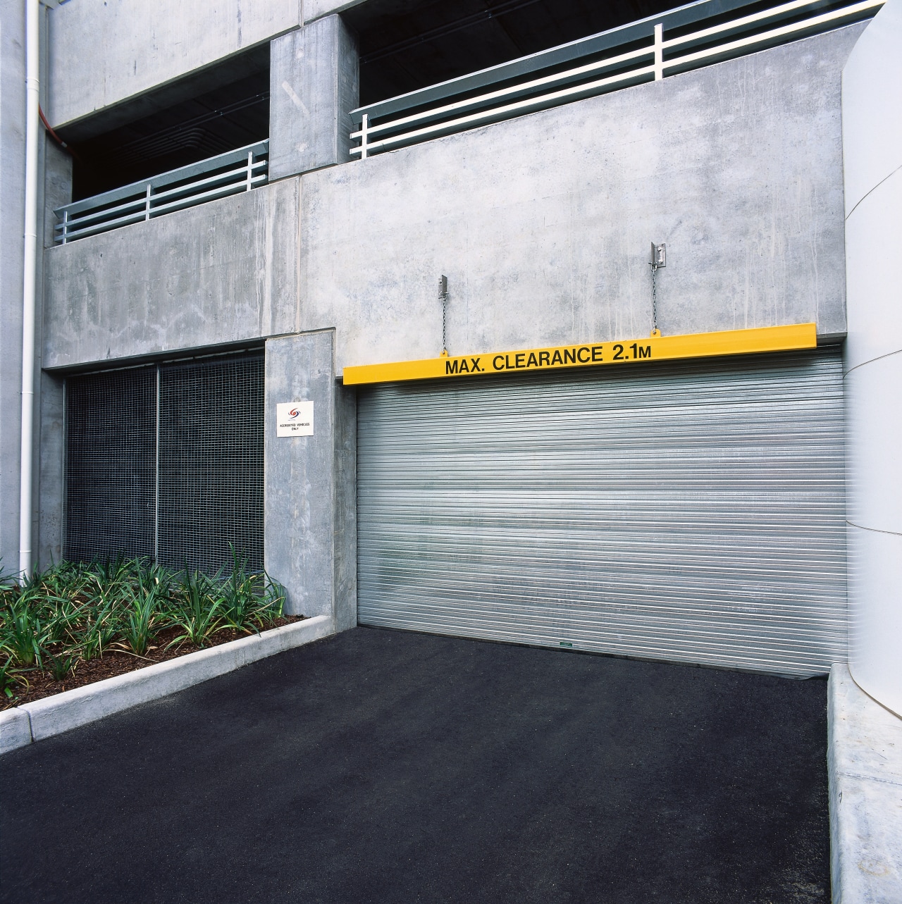 External view of galvanised steel sectional overhead door architecture, asphalt, building, door, facade, real estate, wall, white, black