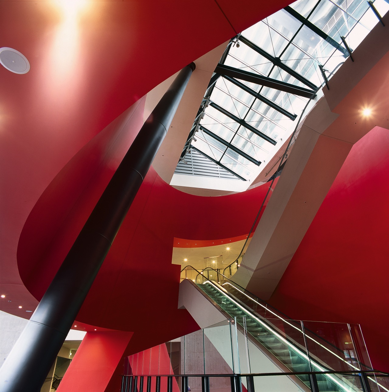 Escalator area with large red conical drum surround angle, architecture, ceiling, daylighting, design, interior design, line, red, structure, red