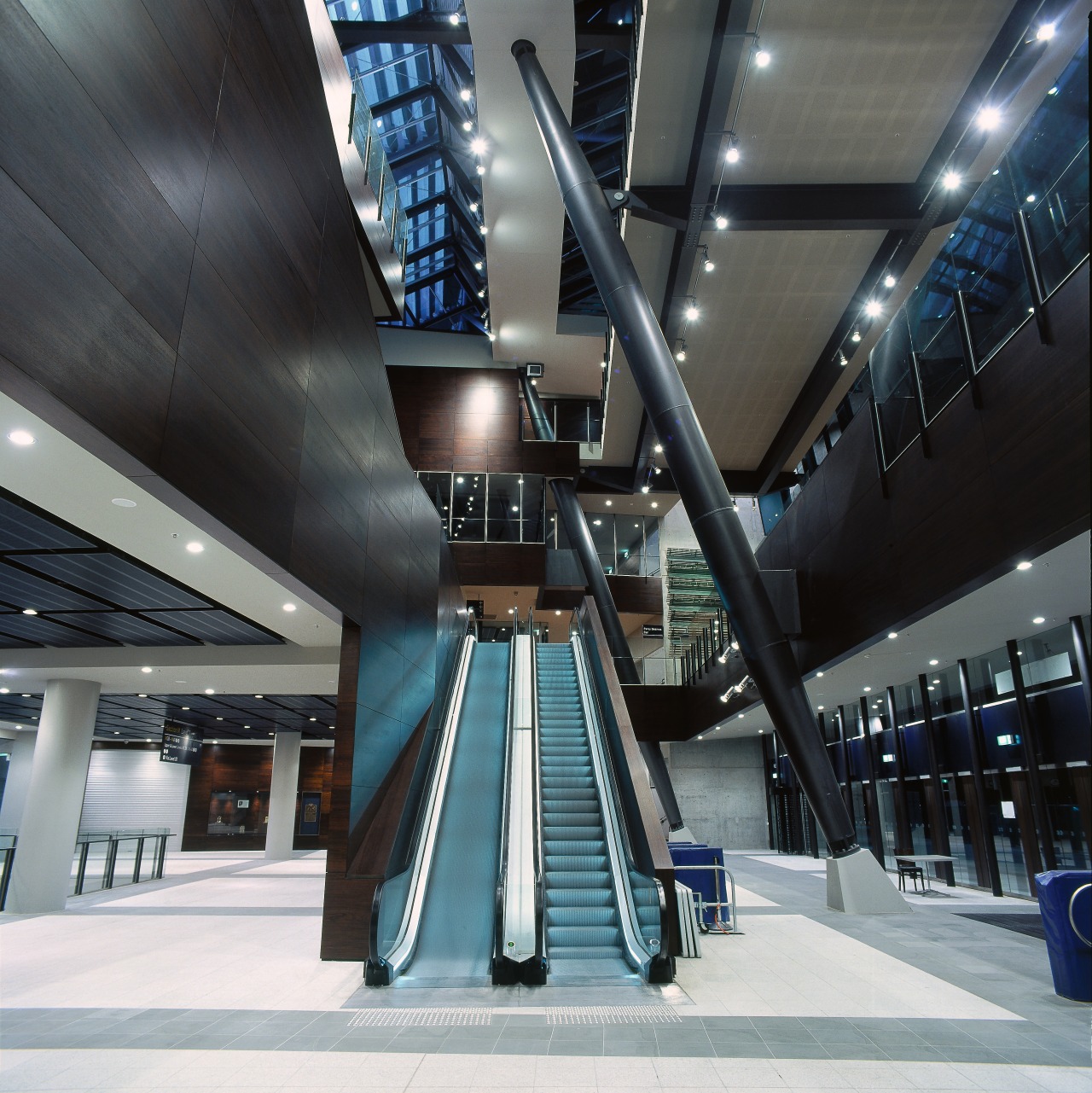 Interior of MCG entranceway showing large atrium, extensive airport terminal, architecture, building, daylighting, escalator, metropolitan area, structure, black, gray