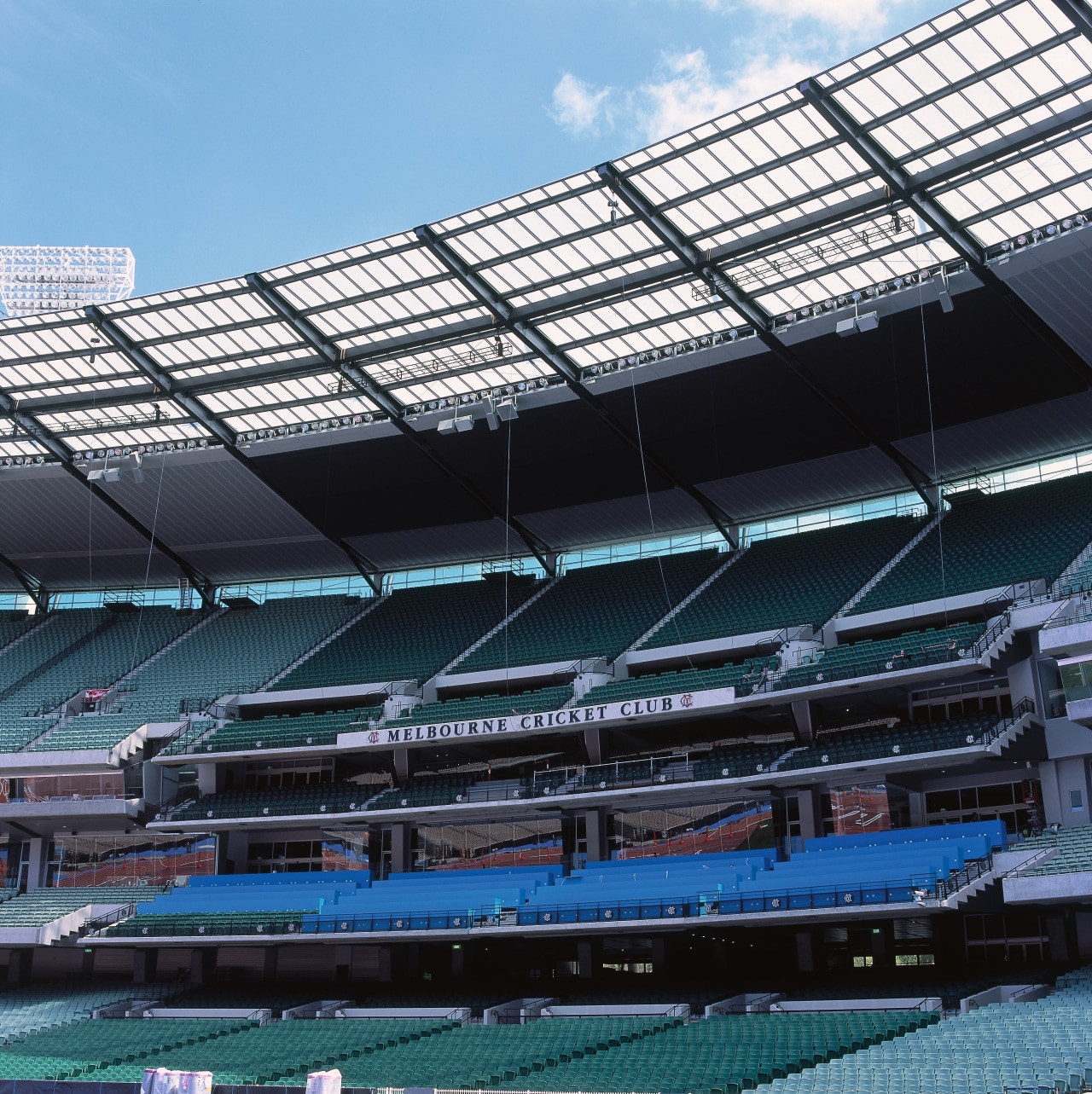 Large sports stadium at the MCG with partially arena, sport venue, stadium, structure, black, teal