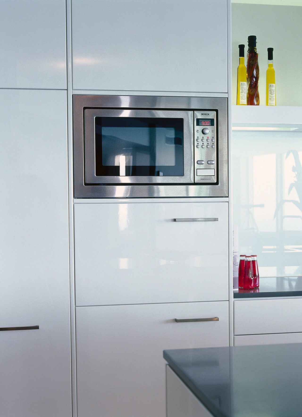 Kitchen with cream cabinetry and stainless steel microwave home appliance, kitchen, kitchen appliance, kitchen stove, major appliance, product, product design, refrigerator, gray