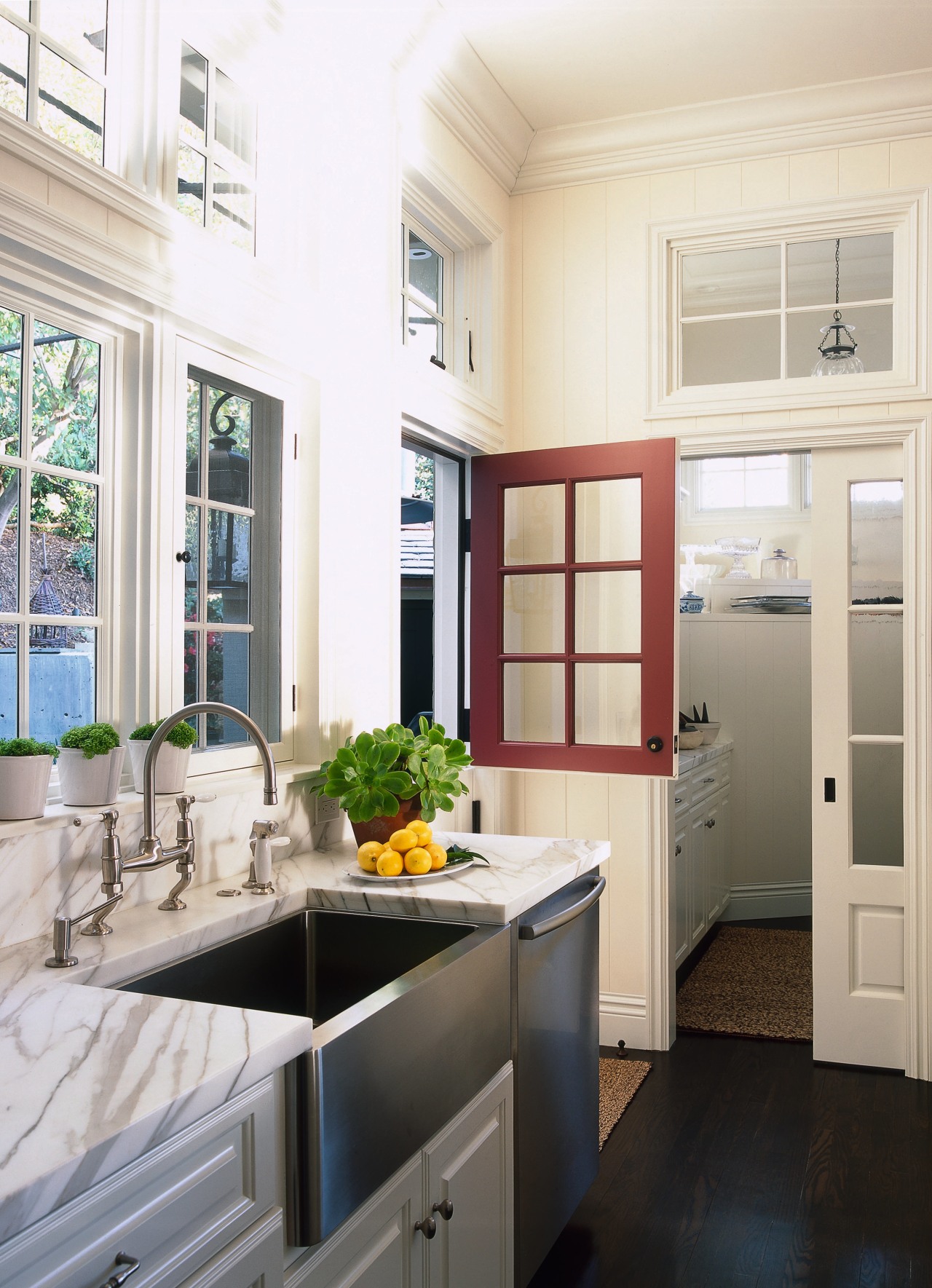 view of this white kitchen featuring white painted cabinetry, countertop, cuisine classique, home, home appliance, interior design, kitchen, window, white