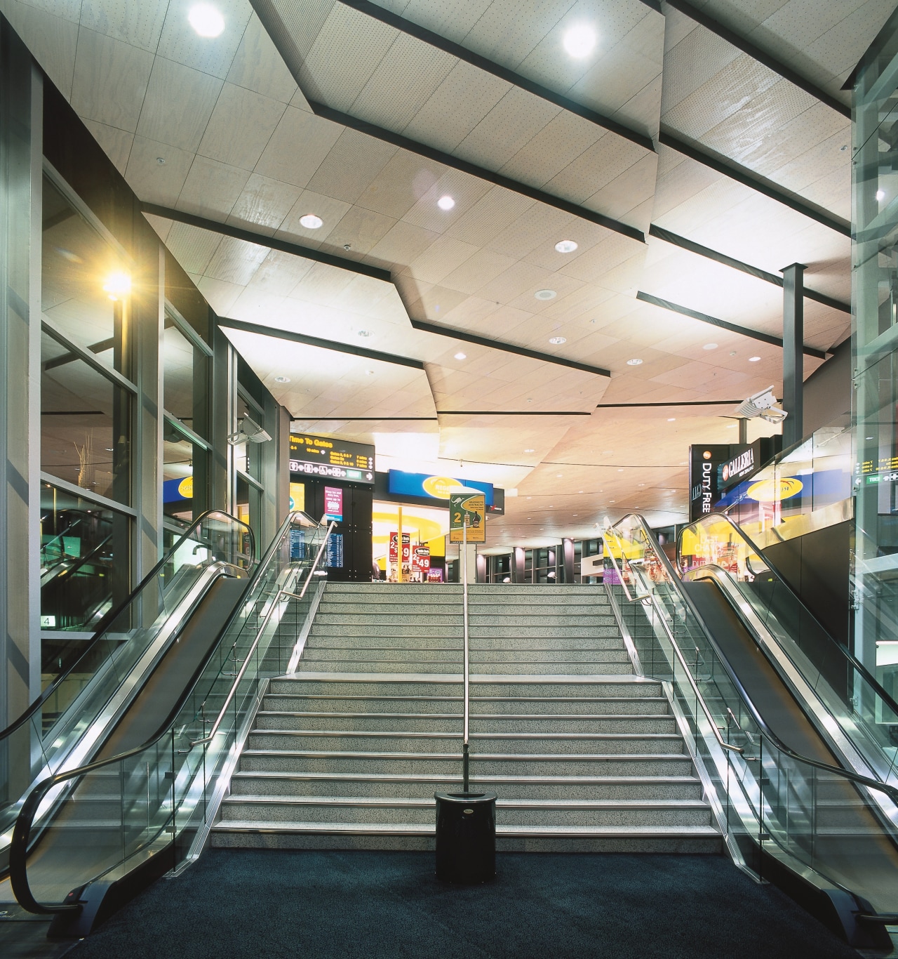 Escalators and stairs at Airport complex. airport terminal, daylighting, escalator, leisure centre, metropolitan area, shopping mall, sport venue, structure, gray, black