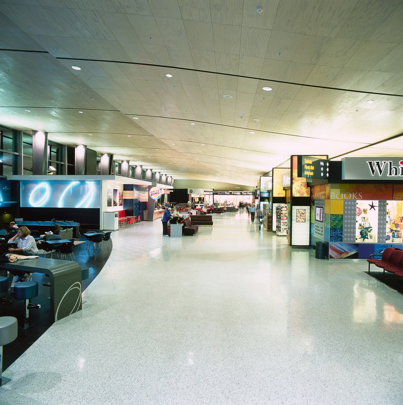 Central walkway through airport with rubber flooring. airport terminal, interior design, retail, shopping mall, white