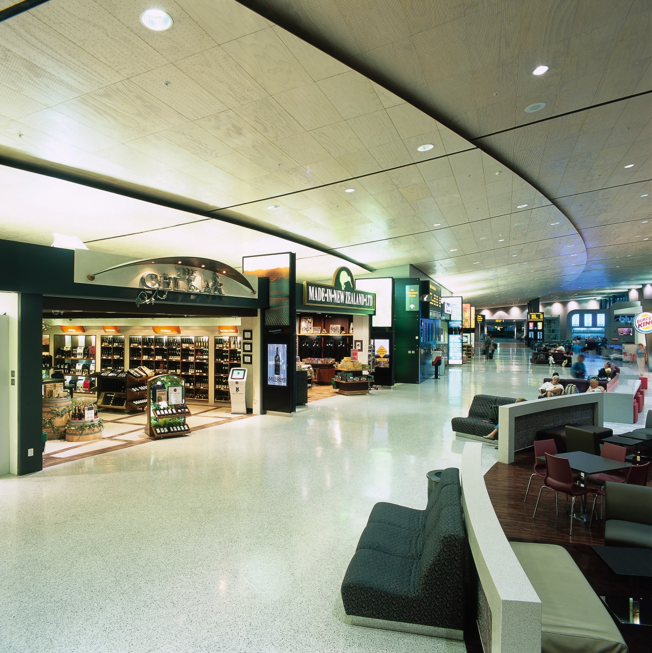 View of retail shops and seating area at interior design, retail, shopping mall