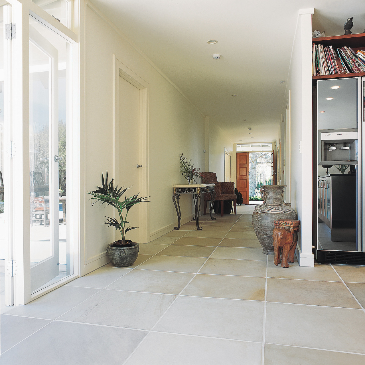 Interior hallway with sandstone paver flooring. floor, flooring, home, interior design, laminate flooring, living room, property, real estate, room, tile, window, wood flooring, white