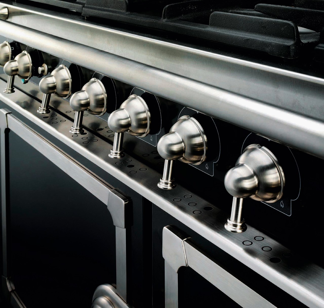 Closeup view of cooker control handles. automotive design, car, metal, motor vehicle, black, gray