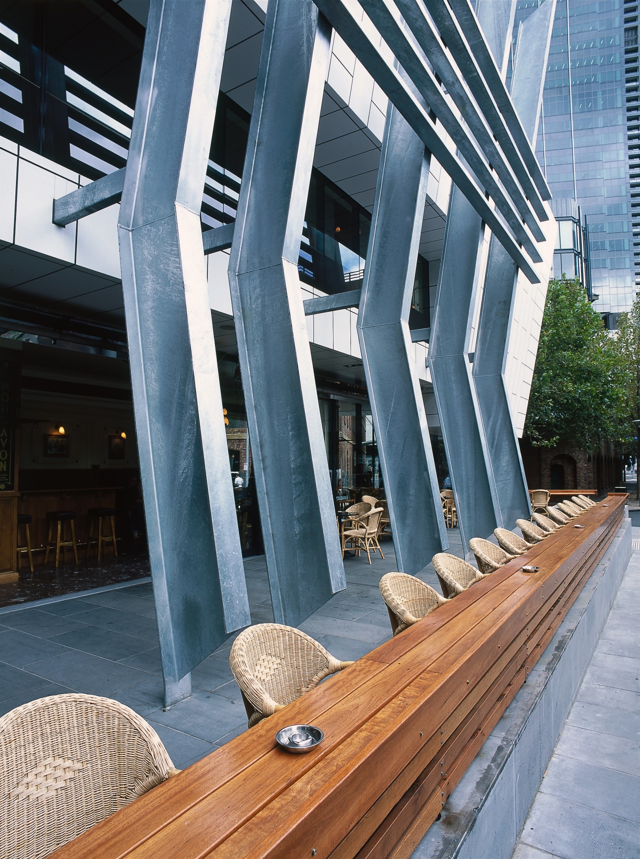 view of the outdoor seating area featuring large architecture, building, condominium, structure, teal