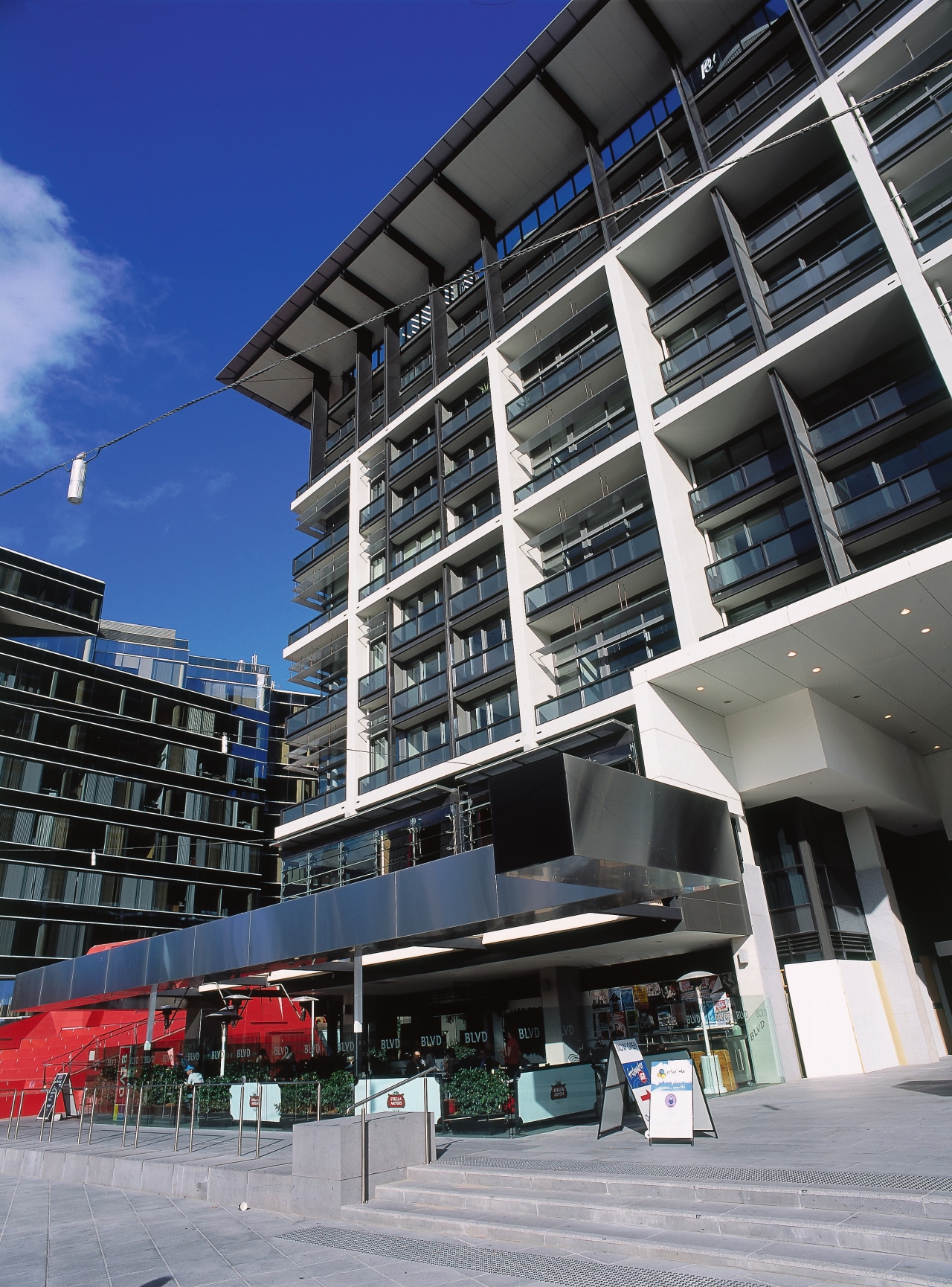 view of the curtain wall facade at freshwater apartment, architecture, building, city, commercial building, condominium, corporate headquarters, facade, metropolitan area, mixed use, residential area, sky, urban area, black