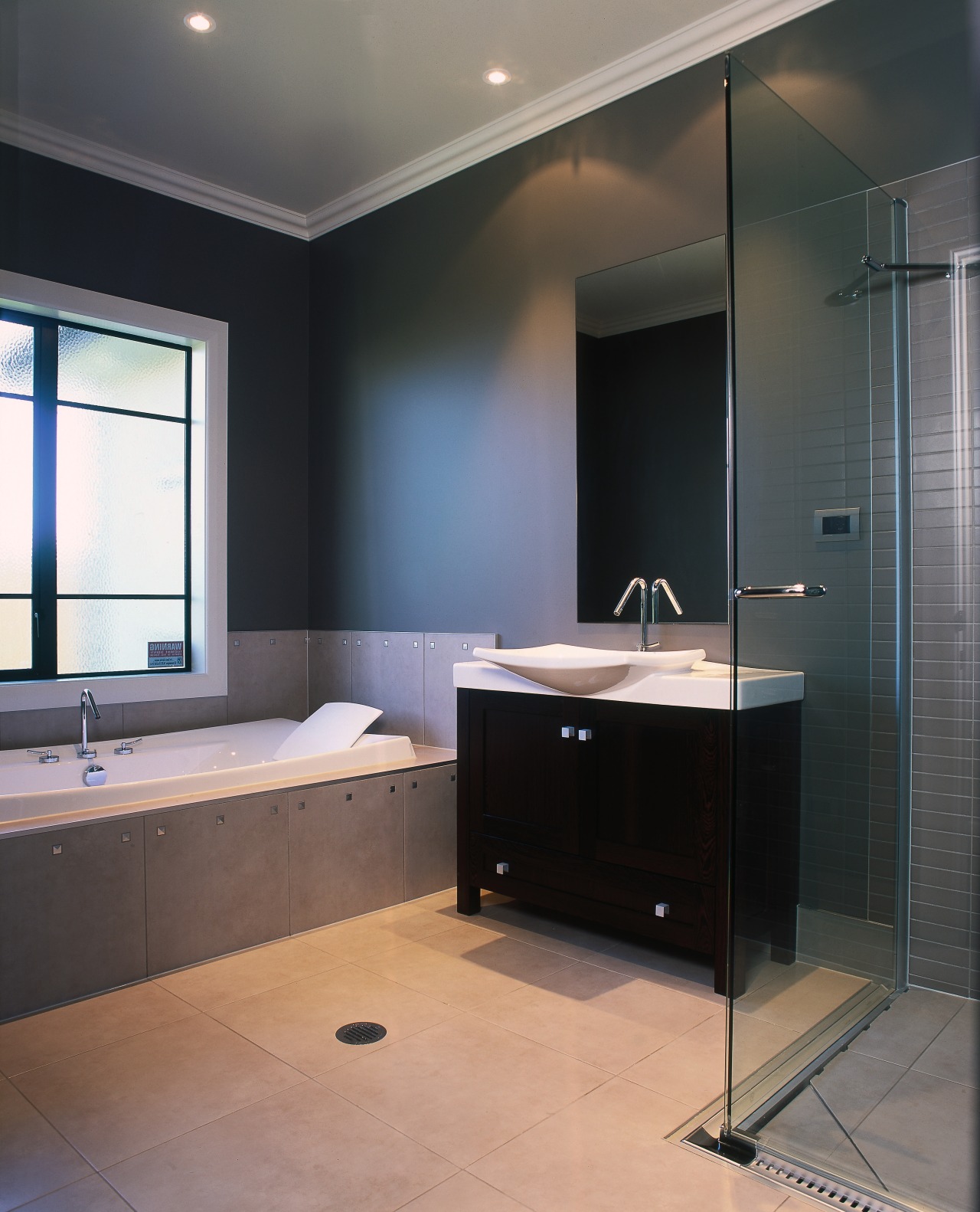 Bathroom with dark cabinet, white bath and glass bathroom, bathroom accessory, bathroom cabinet, floor, glass, interior design, room, sink, black, gray