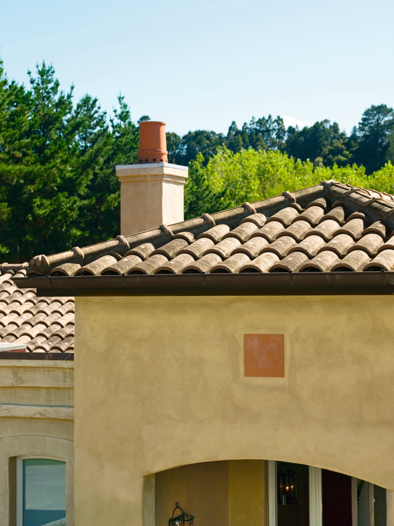View of masonry home with clay roofing tiles. chimney, estate, facade, home, house, outdoor structure, real estate, roof, window, brown, orange